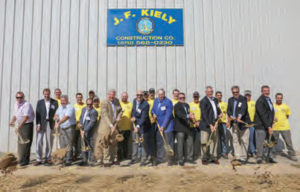 Pictured here at the J.F. Kiely groundbreaking ceremony are:  Local 409 VP Steve Becker, far left, Local President Vinny Hewatt, fourth from left, Nyle, next to him, with John and Jack Kiely, center, company managers and Local 409 members in yellow shirts.